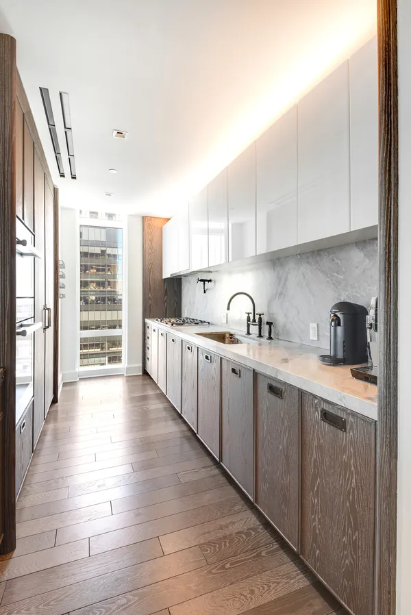 a kitchen with granite countertop a sink and cabinets