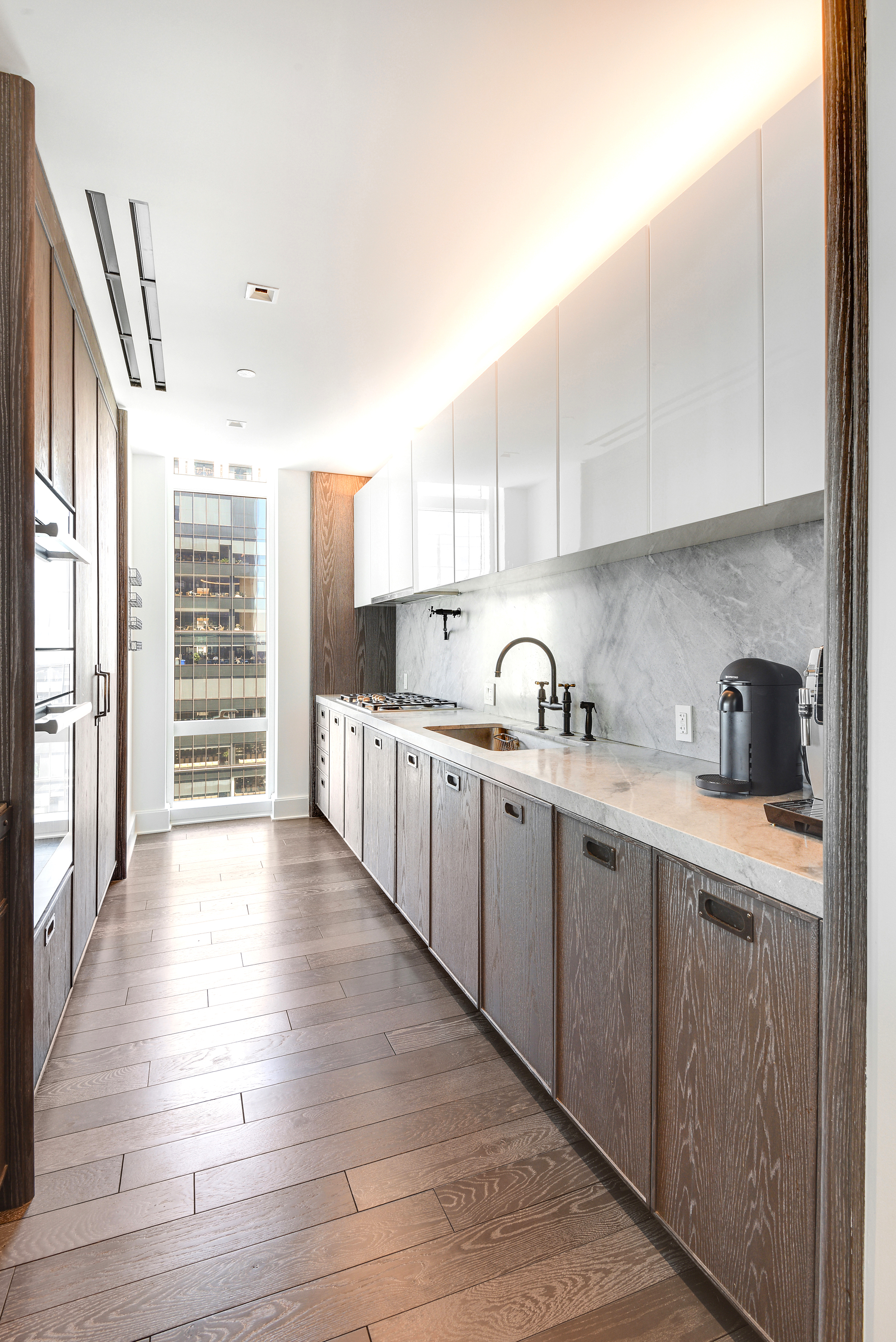 45 East 22nd Street, Unit 34A Manhattan, NY 10010 - Photo 5 of 24 a kitchen with granite countertop a sink and cabinets