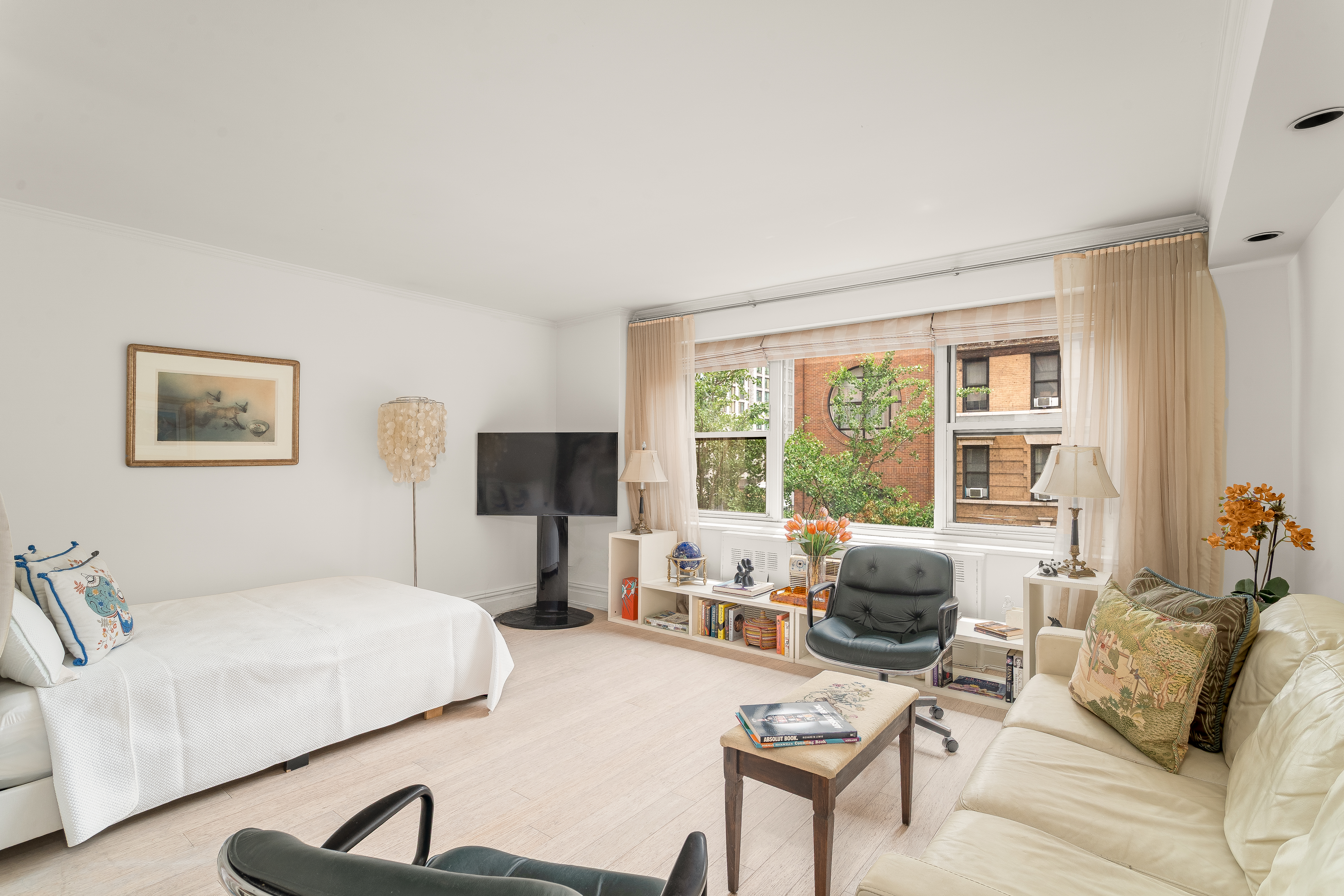 251 East 51st Street, Unit 6K Manhattan, NY 10022 - Photo 4 of 16 a living room with furniture and a large window