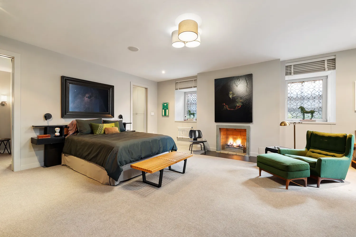 a spacious bedroom with a bed and a flat screen tv