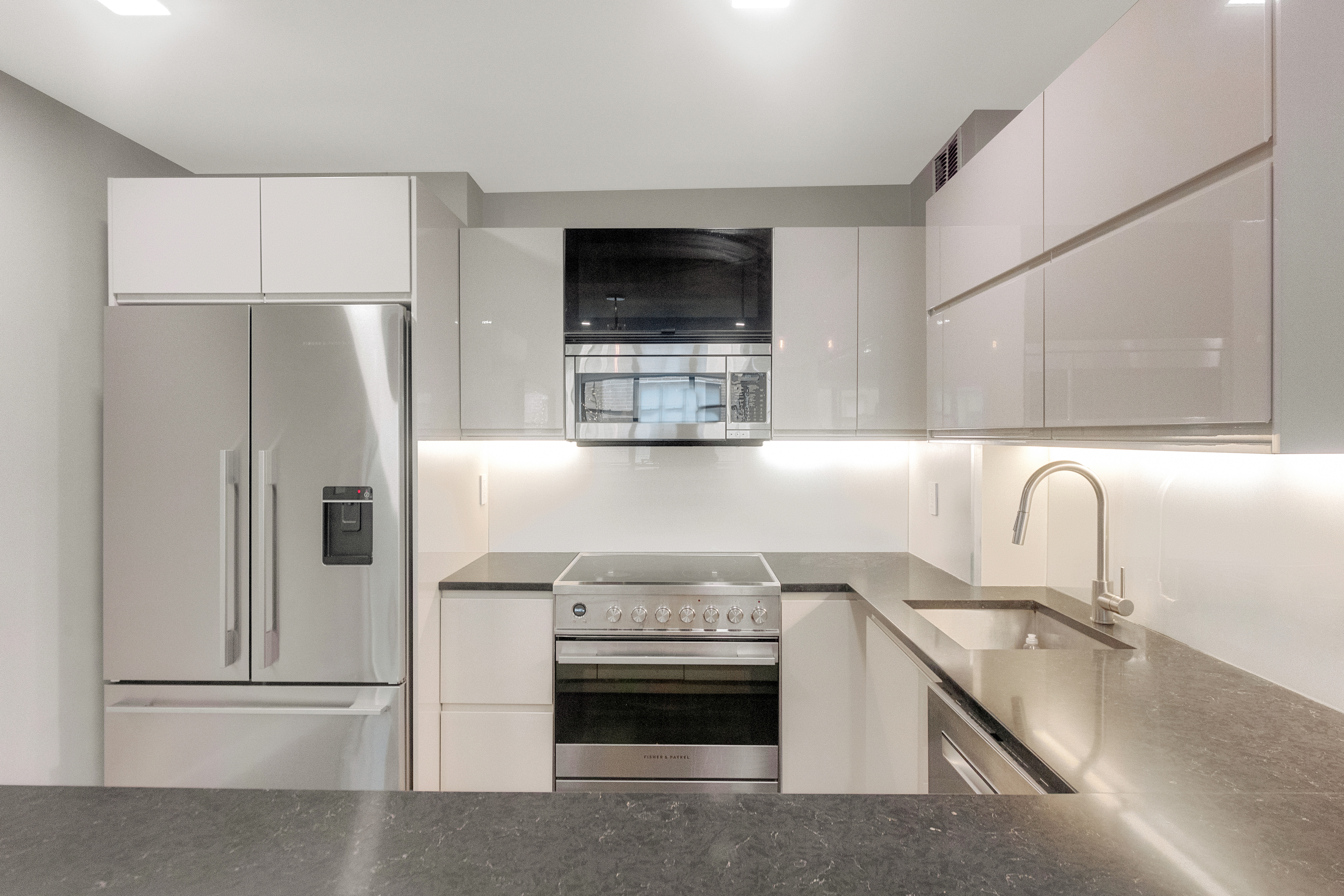2 Tudor City Place, Unit 12DS Manhattan, NY 10017 - Photo 7 of 20 a kitchen with stainless steel appliances a refrigerator stove and sink