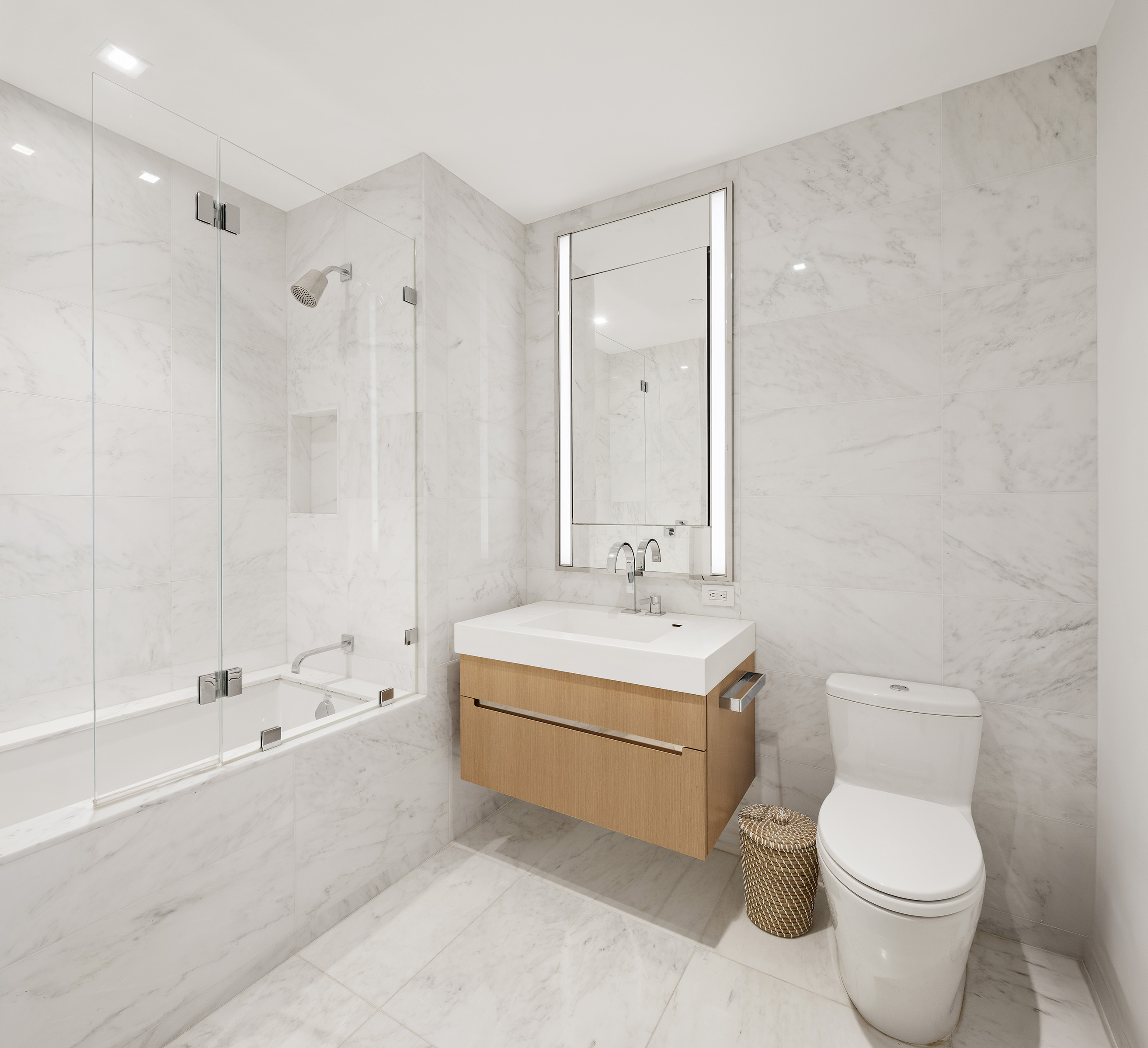 1 West End Avenue, Unit 12D Manhattan, NY 10023 - Photo 10 of 32 a bathroom with a sink toilet a mirror and bathtub