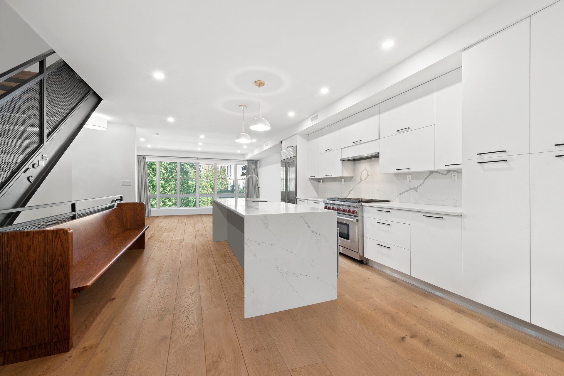 65 Bainbridge Street Brooklyn, NY 11233 - Photo 5 of 24 a large kitchen with white cabinets and stainless steel appliances