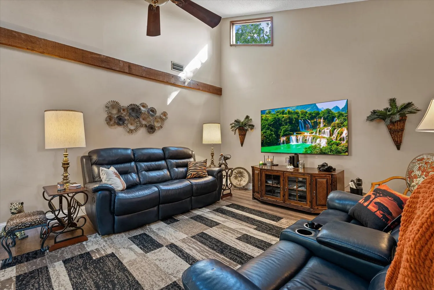 a view of a dining room with furniture a chandelier and wooden floor