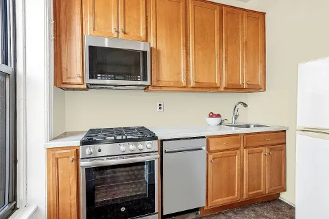 a kitchen with granite countertop a stove and a sink