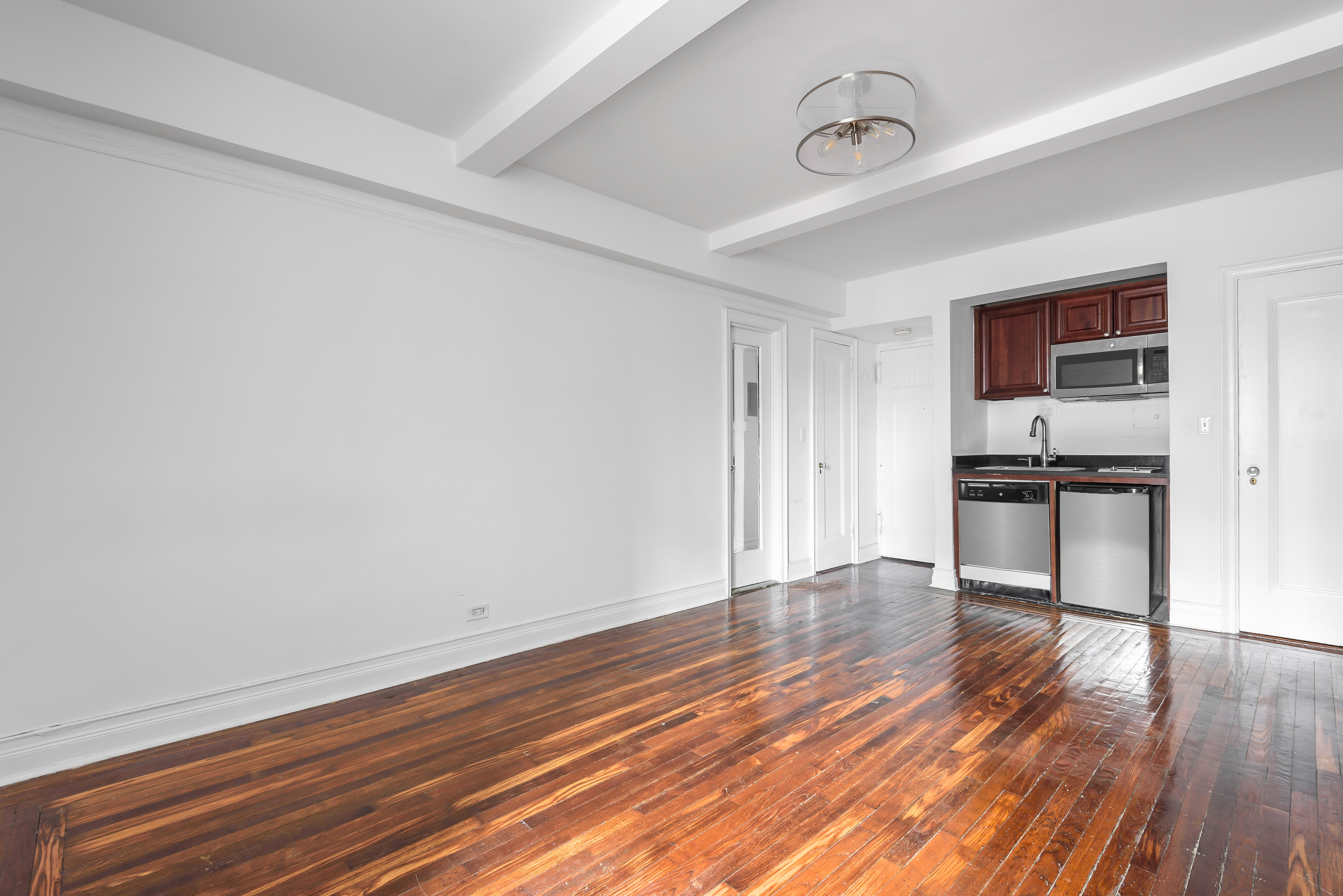 5 Tudor City Place, Unit 1607 Manhattan, NY 10017 - Photo 2 of 5 a view of kitchen with wooden floor and electronic appliances