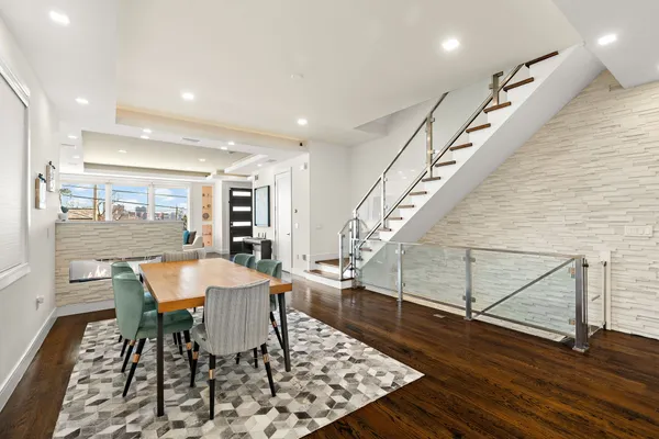 a dining room with furniture and wooden floor