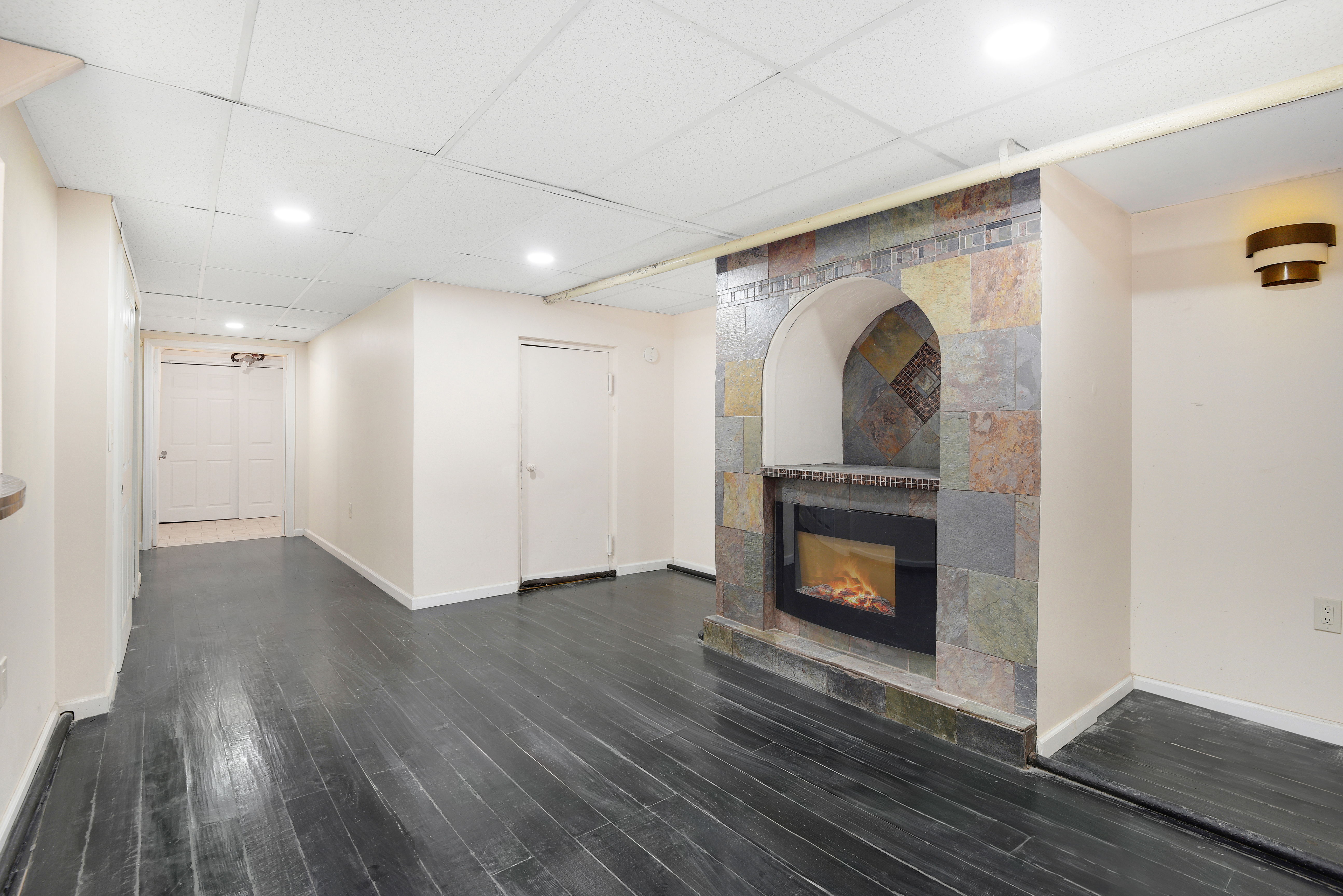 615 Willoughby Avenue, Unit 1 Brooklyn, NY 11206 - Photo 10 of 13 a view of empty room with wooden floor fireplace and window