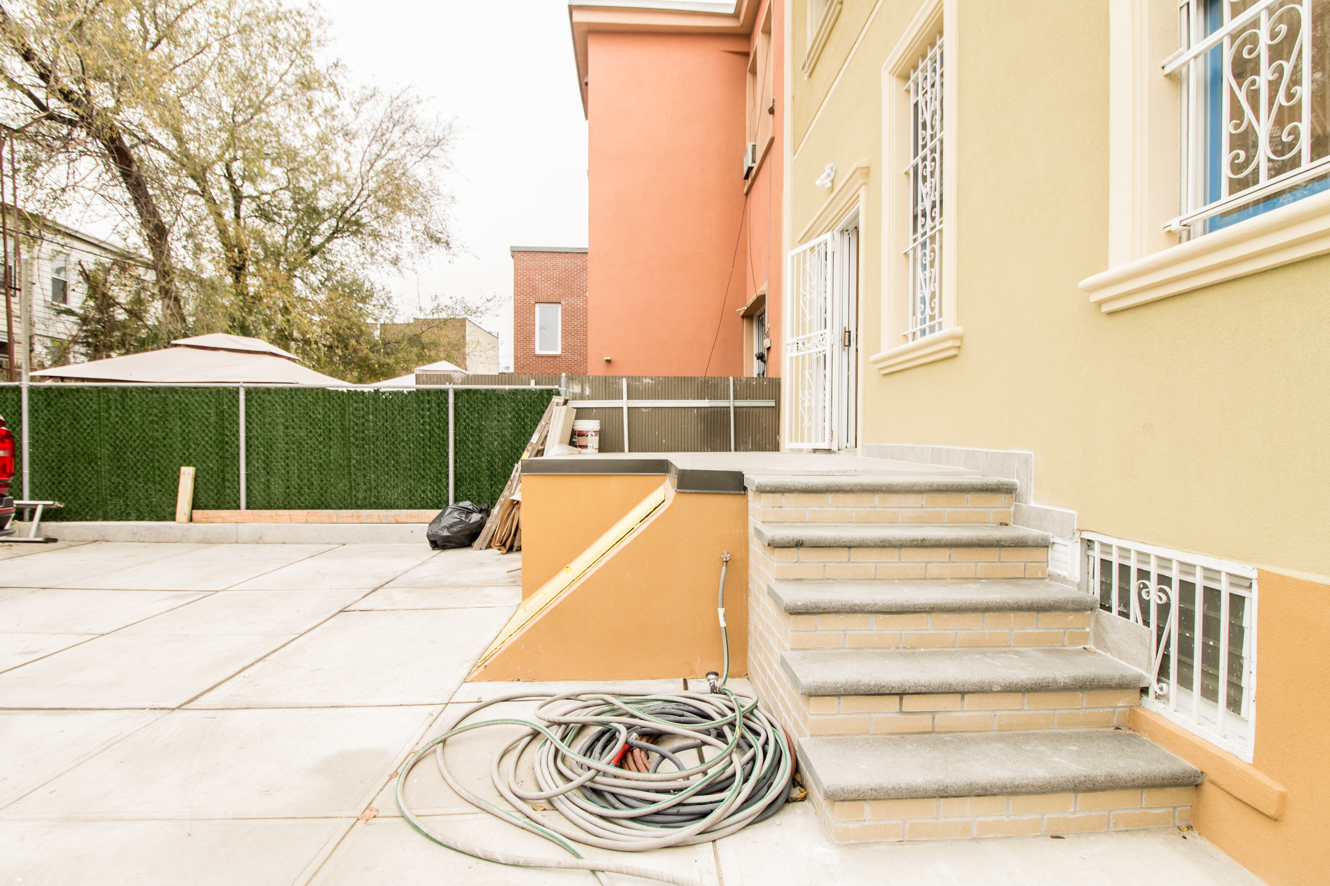 1923 Cornelia Street, Unit 2F Queens, NY 11385 - Photo 9 of 9 a view of a swimming pool with a bench and tables