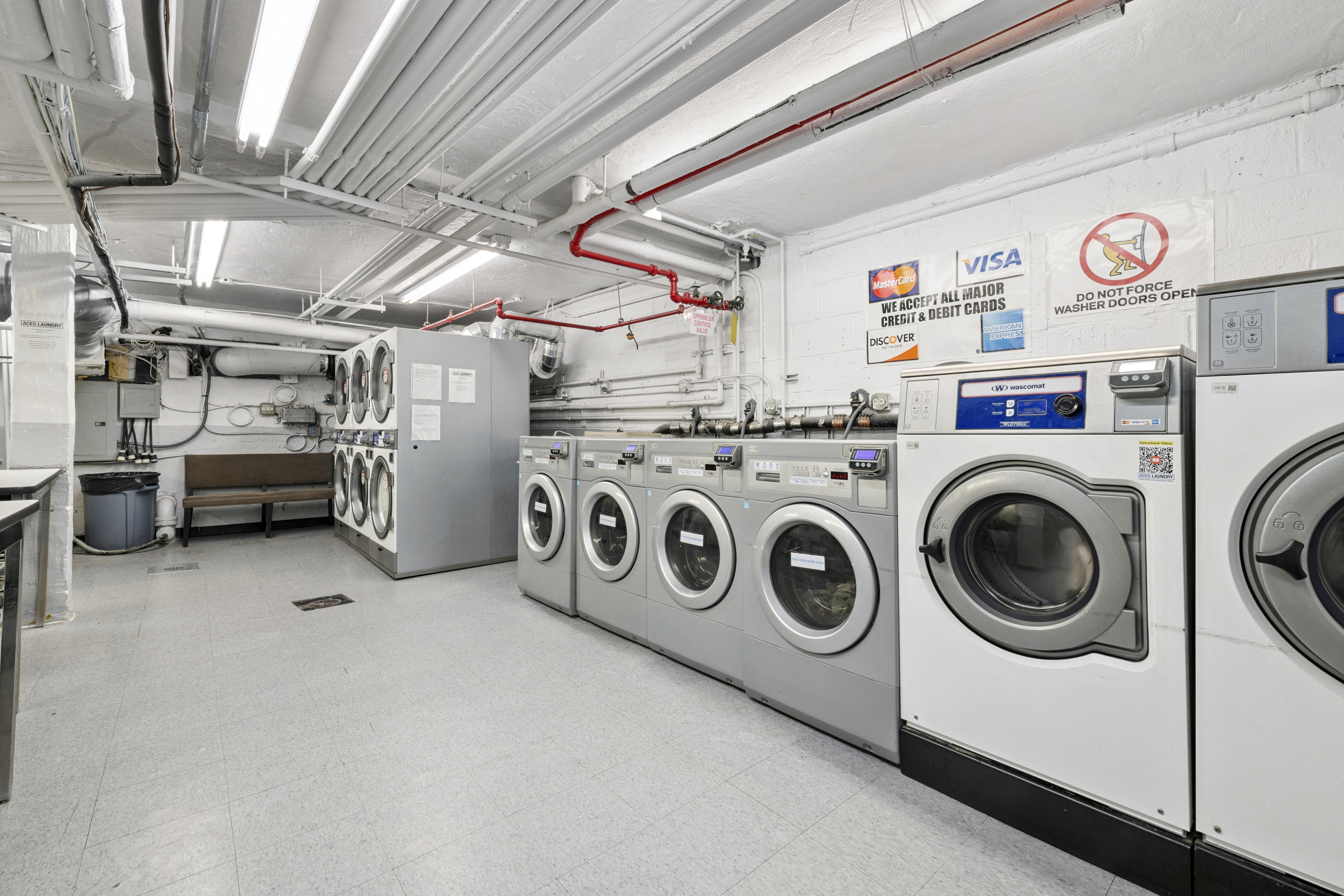 235 East 57th Street, Unit 5D Manhattan, NY 10022 - Photo 8 of 10 a utility room with dryer and washer