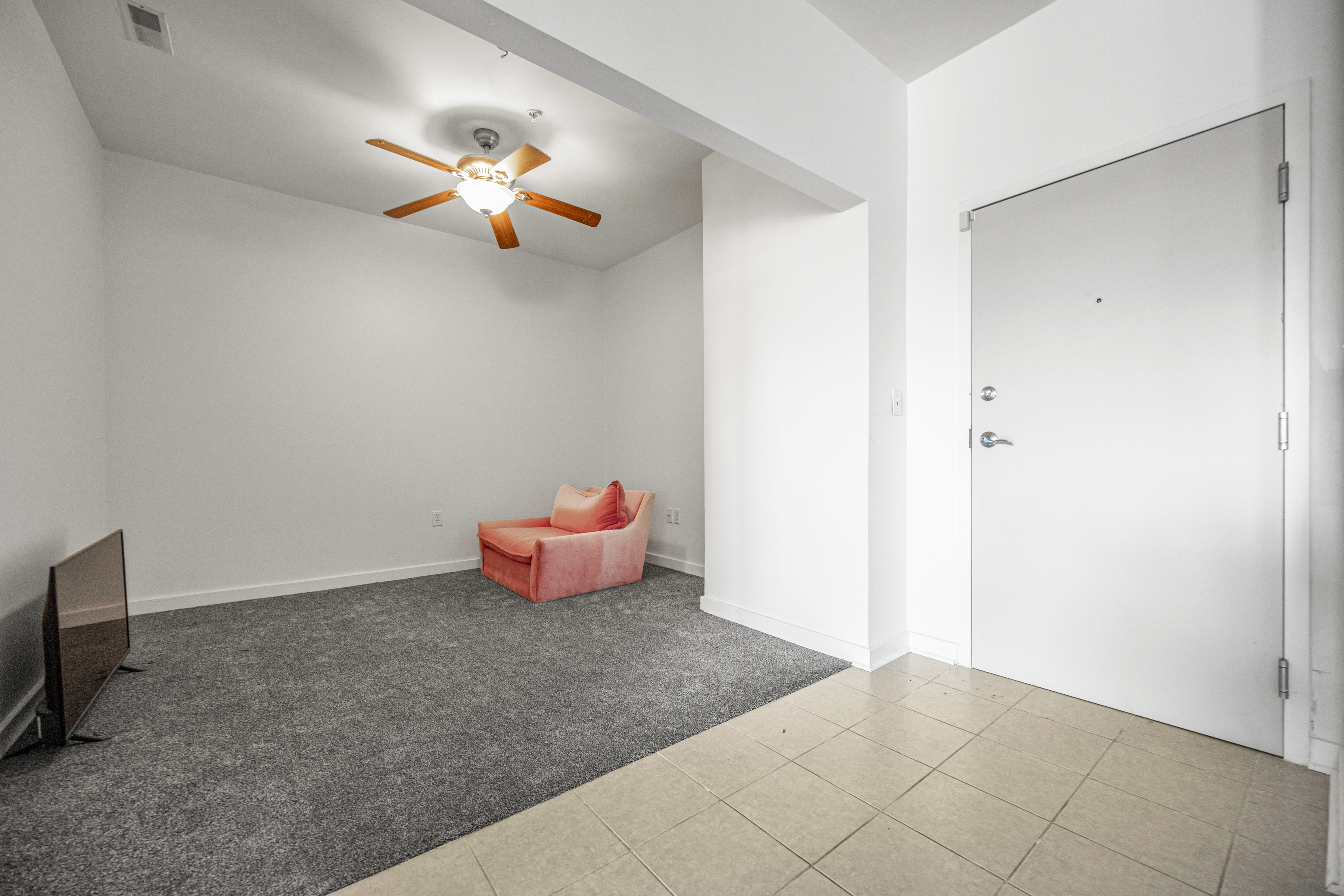 3201 St Paul Street, Unit 310 Baltimore, MD 21218 - Photo 12 of 20 a view of a room with wooden floor and chandelier fan