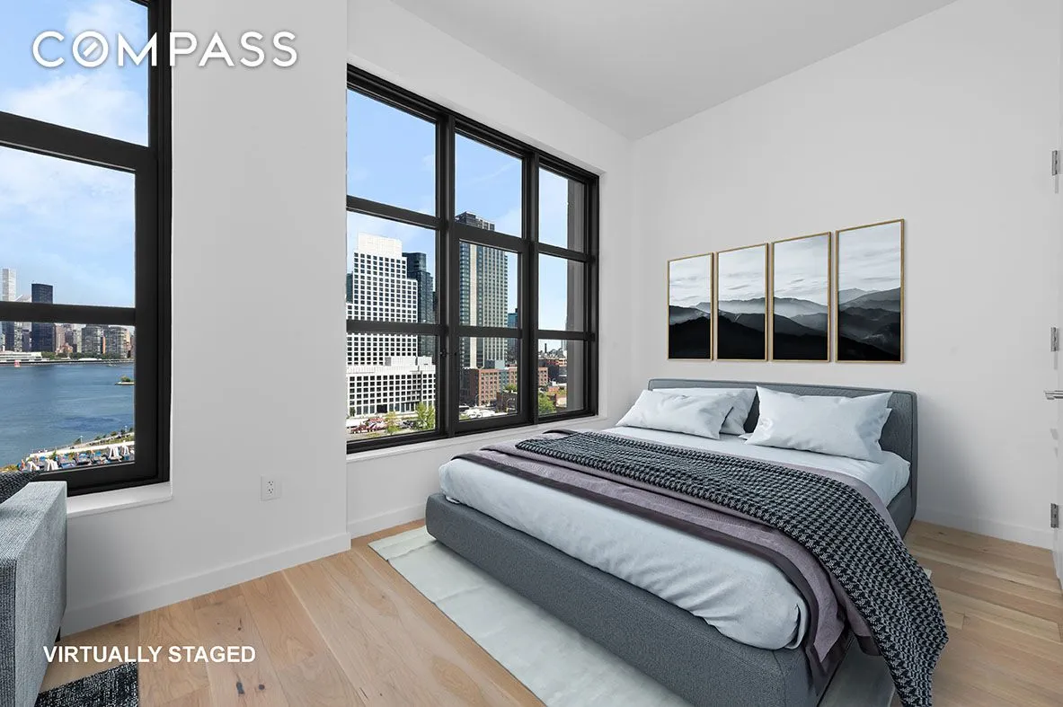 a bedroom with a bed and a large window