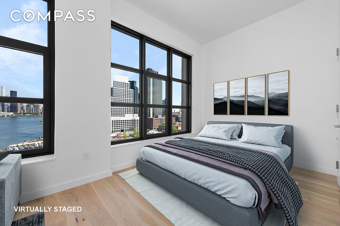 29 Huron Street, Unit 10AW Brooklyn, NY 11222 - Photo 5 of 13 a bedroom with a bed and a large window