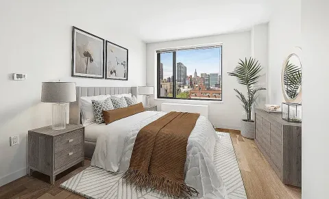 a bedroom with a bed and a lamp on table