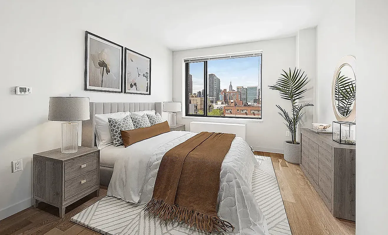 46-09 11th Street, Unit 6D Queens, NY 11101 - Photo 5 of 14 a bedroom with a bed and a lamp on table