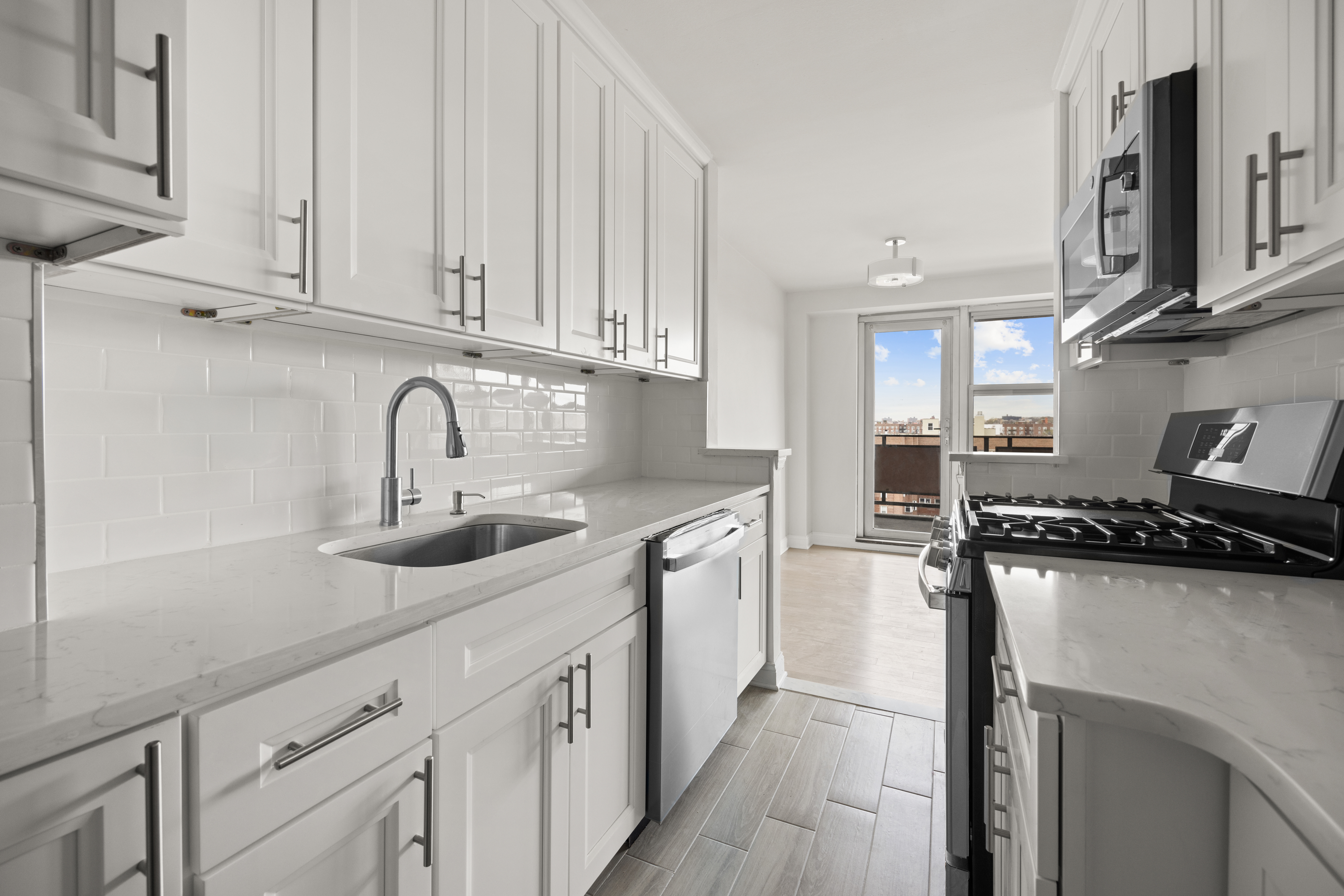 135 Ocean Parkway, Unit 9M Brooklyn, NY 11218 - Photo 6 of 18 a kitchen with stainless steel appliances a sink a stove and cabinets