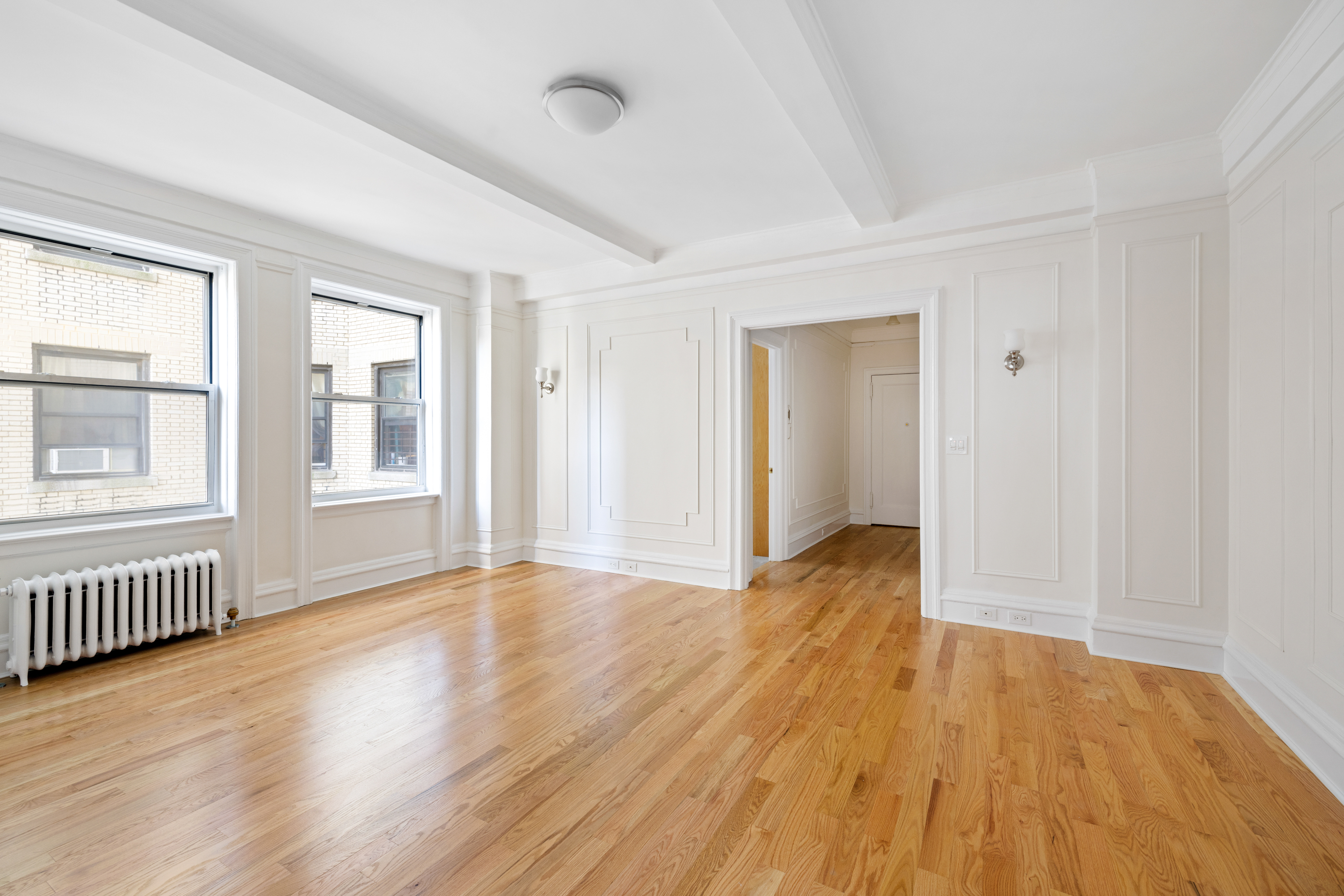 240 West 98th Street, Unit 7D Manhattan, NY 10025 - Photo 10 of 14 a view of an empty room with wooden floor and a window