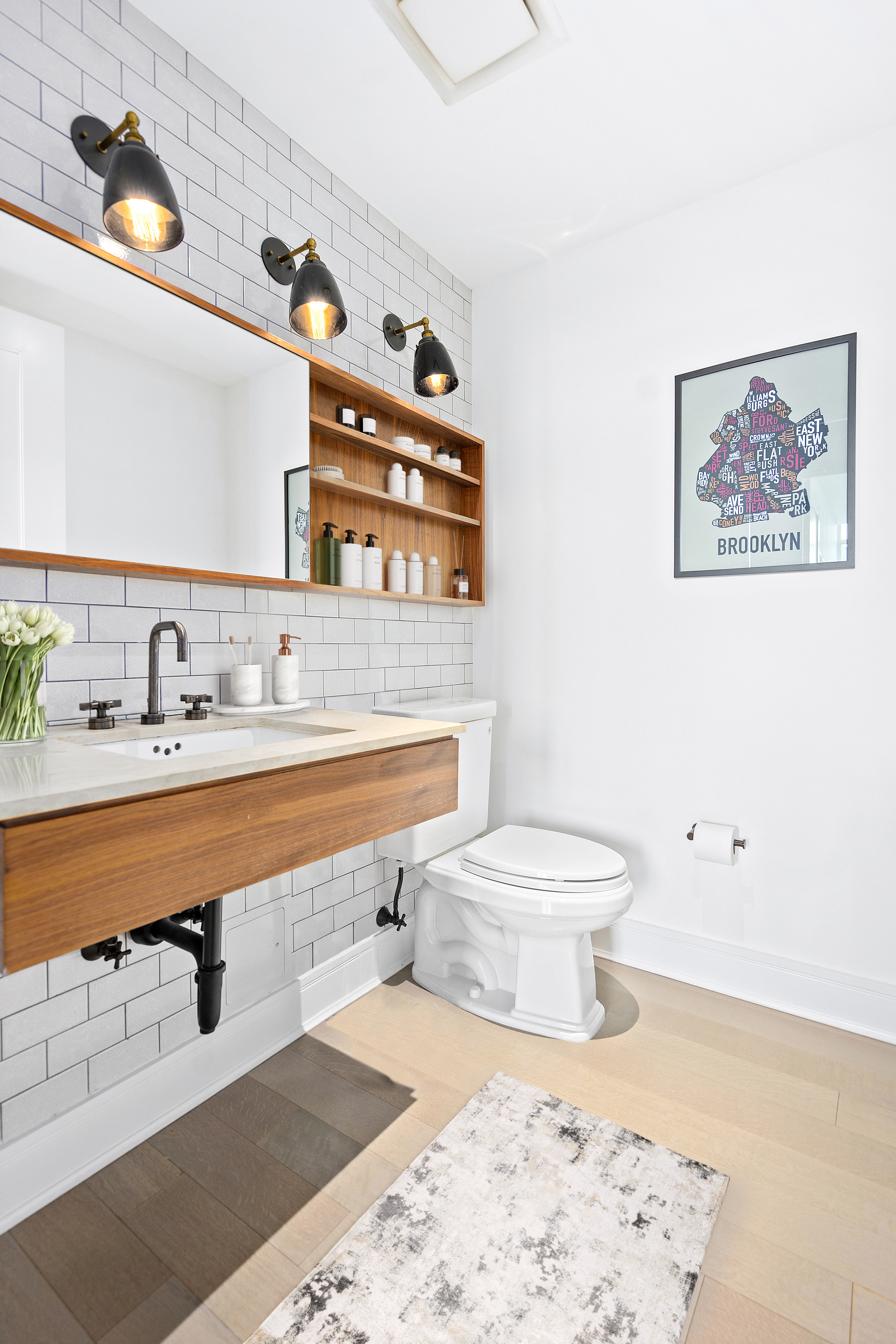 265 State Street, Unit 1601 Brooklyn, NY 11201 - Photo 13 of 14 a bathroom with a toilet a sink and a mirror