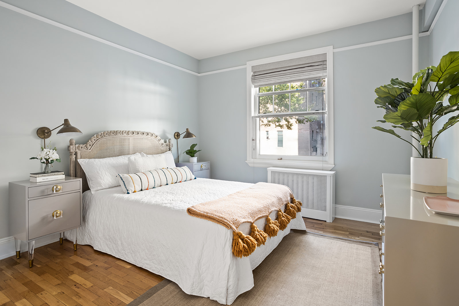 35-16 79th Street, Unit 1 Queens, NY 11372 - Photo 5 of 14 a bedroom with a bed and a potted plant