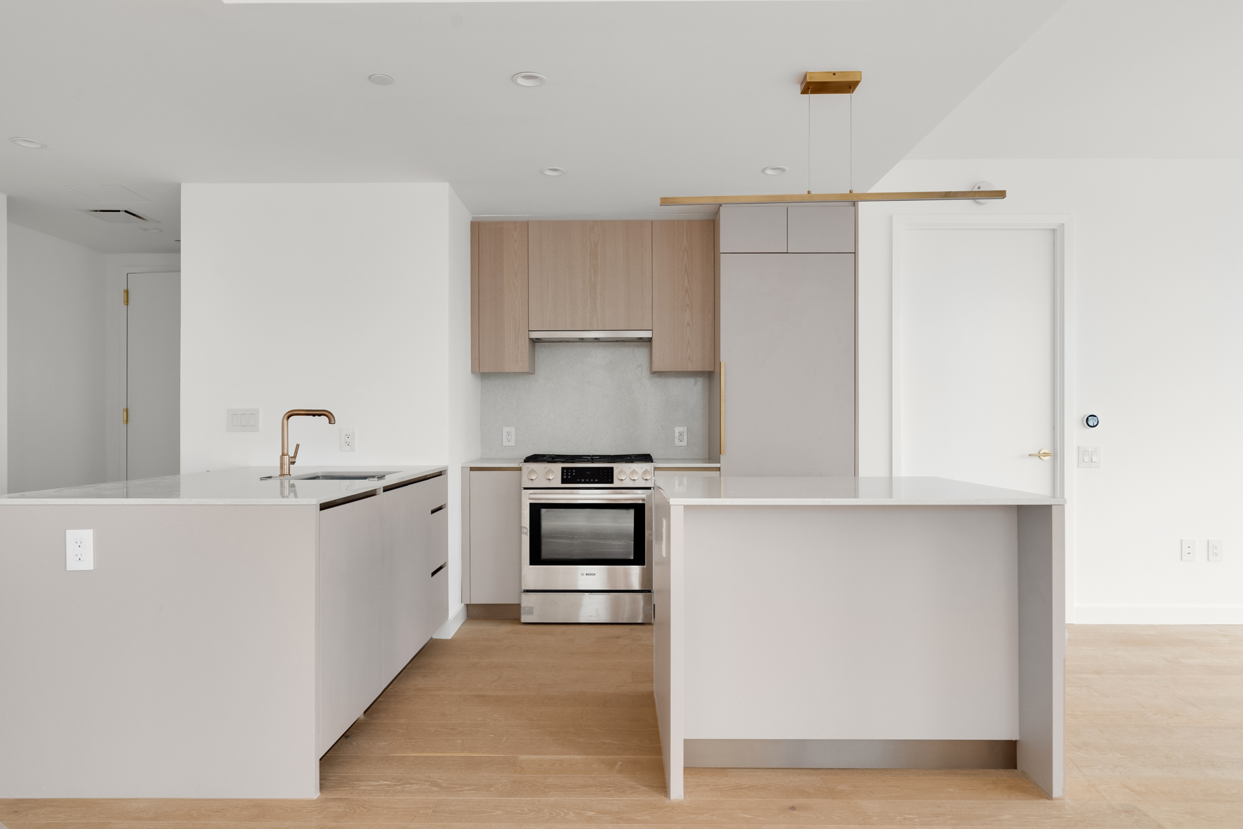 3 Court Square, Unit 2911 Queens, NY 11101 - Photo 4 of 22 a kitchen with white cabinets and appliances