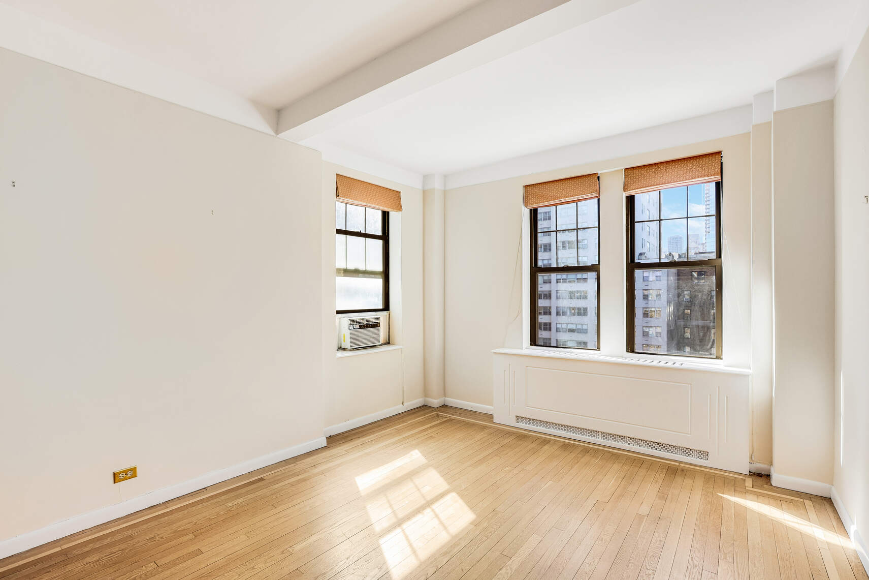 23 West 73rd Street, Unit 1405A Manhattan, NY 10023 - Photo 3 of 9 an empty room with wooden floor and windows