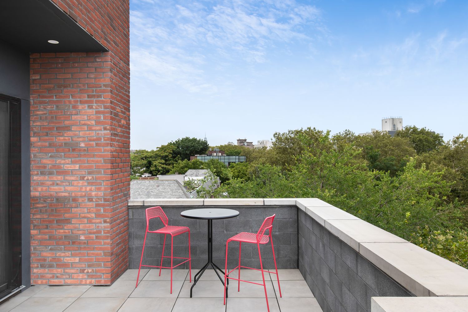 a balcony with table and chairs