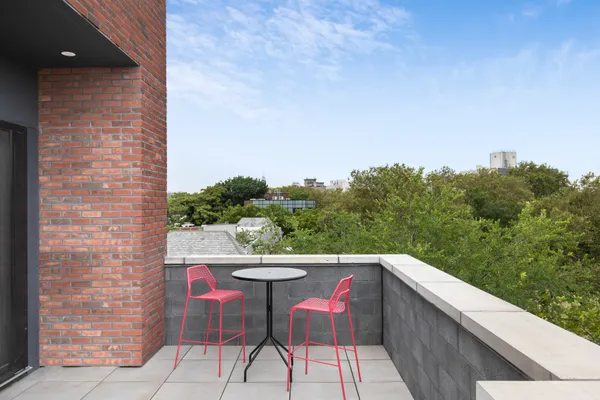 a balcony with table and chairs