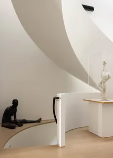 a kitchen with stainless steel appliances kitchen island granite countertop a table chairs in it and white cabinets