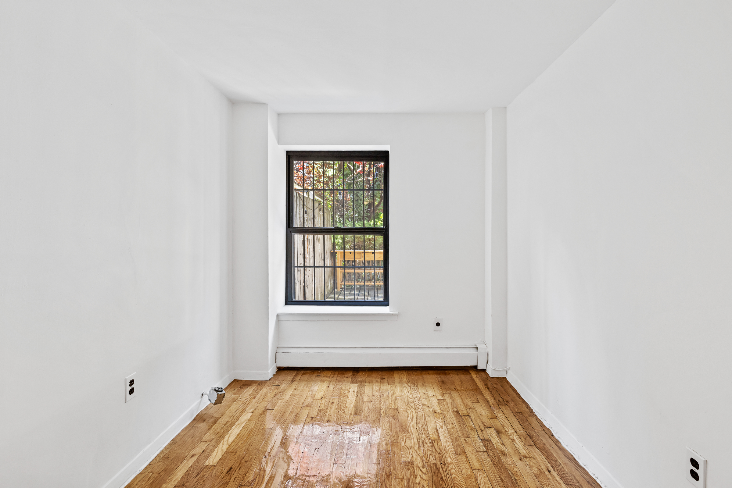 662 Warren Street Brooklyn, NY 11217 - Photo 7 of 9 a view of a room with wooden floor and window
