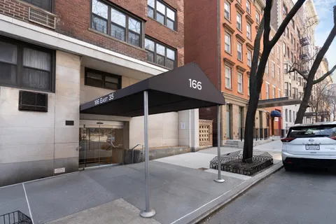 a view of a building with car parked