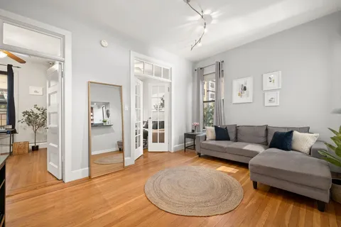 a living room with furniture and a wooden floor