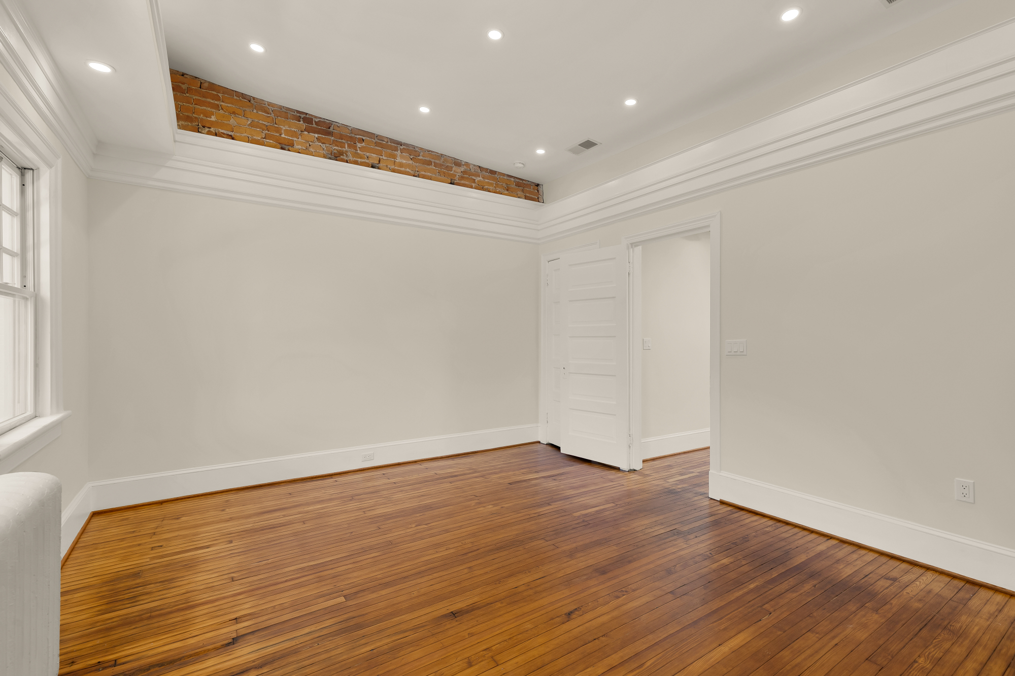 1737 Park Road Northwest Washington, DC 20010 - Photo 17 of 32 a view of an empty room with wooden floor and a window