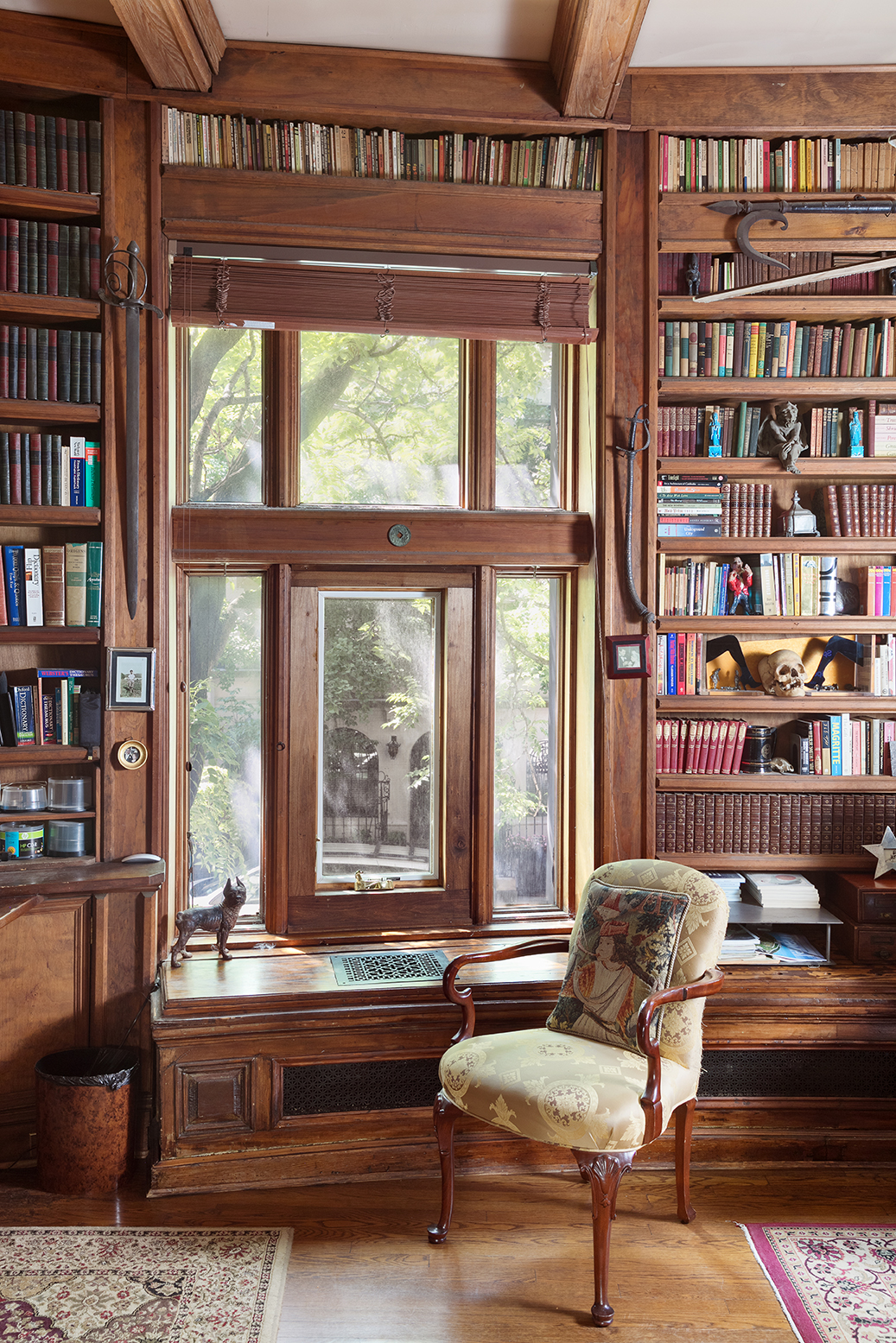 323 West 80th Street Manhattan, NY 10024 - Photo 14 of 24 a living room with furniture and a book shelf