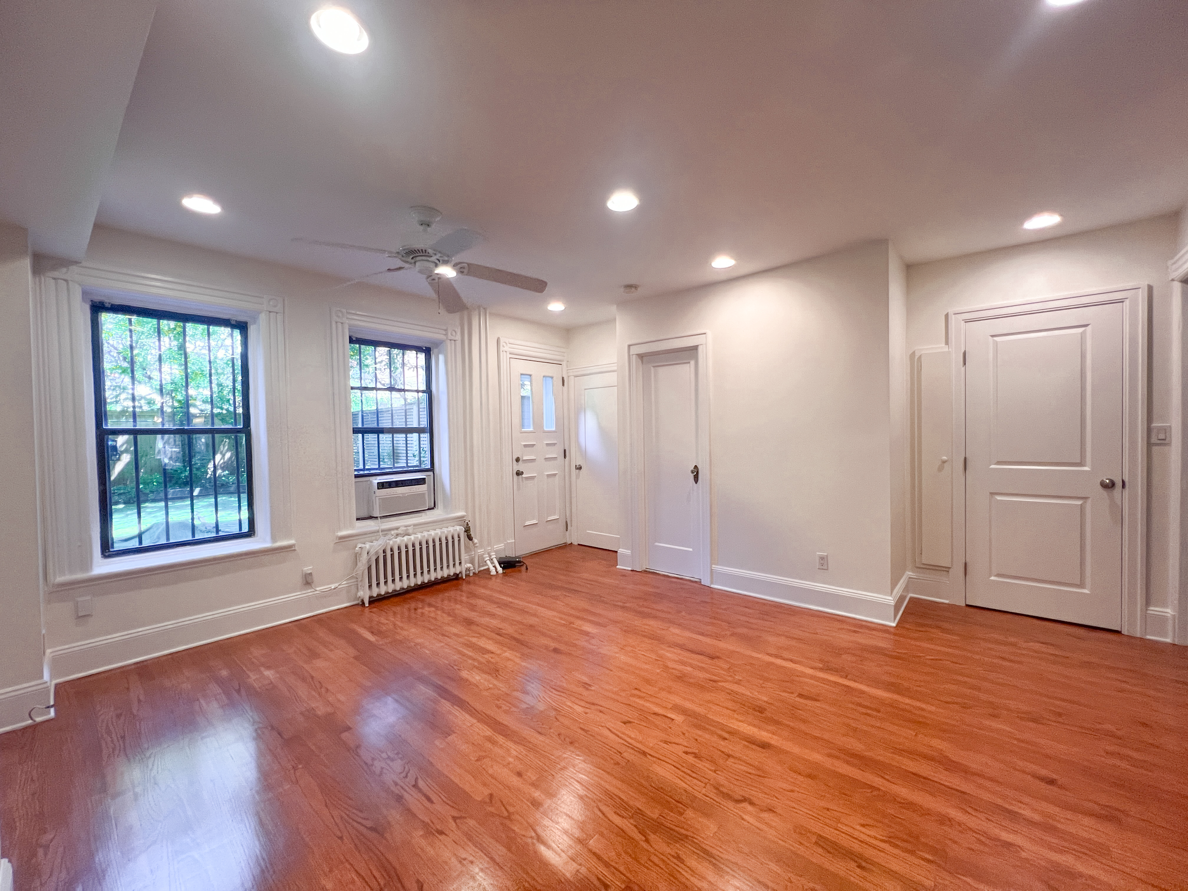 651 10th Street, Unit 1 Brooklyn, NY 11215 - Photo 4 of 15 a view of an empty room with wooden floor and a window