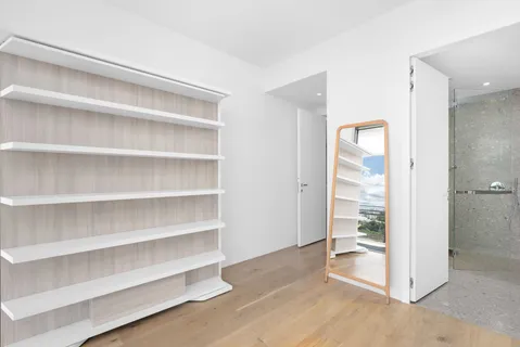 a view of walk in closet with empty racks