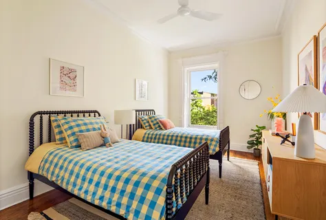 a bedroom with two beds and a table