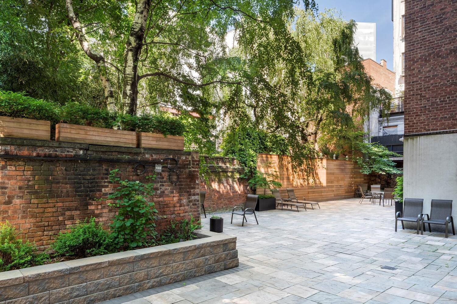 305 West 18th Street, Unit 6A Manhattan, NY 10011 - Photo 3 of 7 a view of a yard with plants and trees
