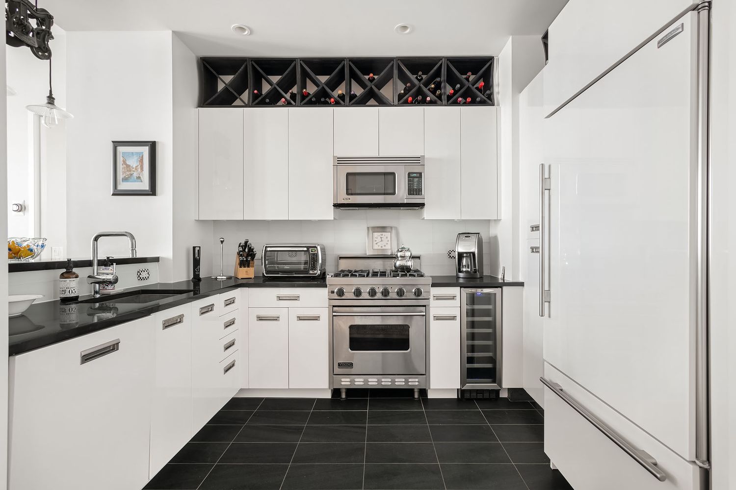 a kitchen with a stove a sink and a refrigerator