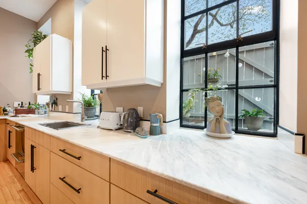 a kitchen with a sink and a large window