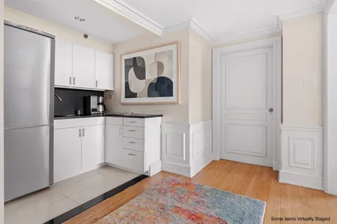 a view of a kitchen with wooden floor and electronic appliances