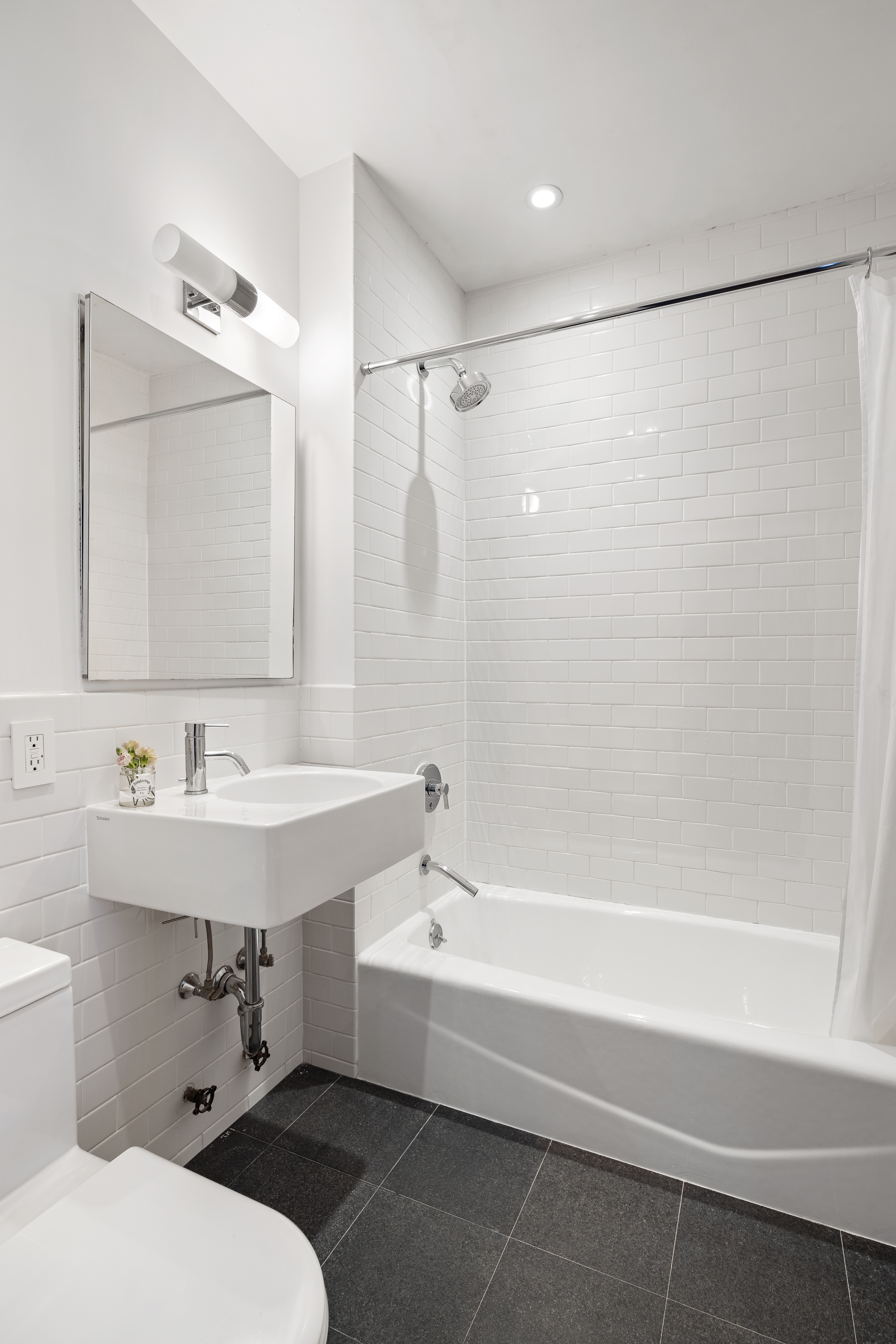 175 East Broadway, Unit 6D Manhattan, NY 10002 - Photo 13 of 18 a bathroom with a sink and a mirror