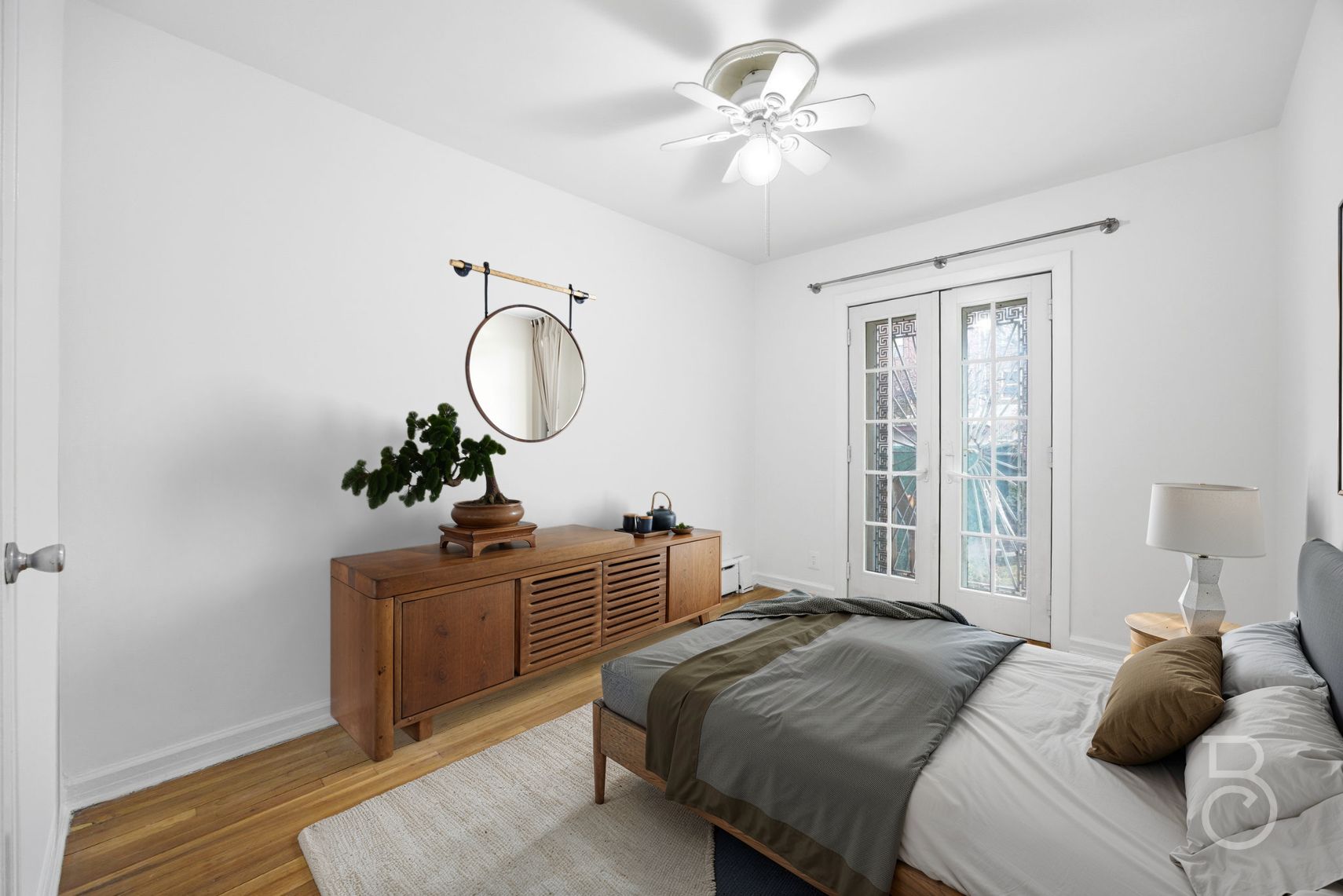 22-61 46th Street Queens, NY 11105 - Photo 8 of 24 a bedroom with a bed and a chandelier