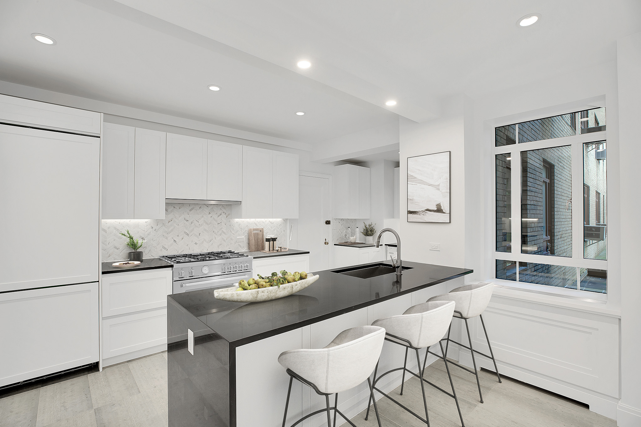 25 Central Park West, Unit 2Q Manhattan, NY 10023 - Photo 10 of 12 a kitchen with stainless steel appliances kitchen island granite countertop a sink and cabinets