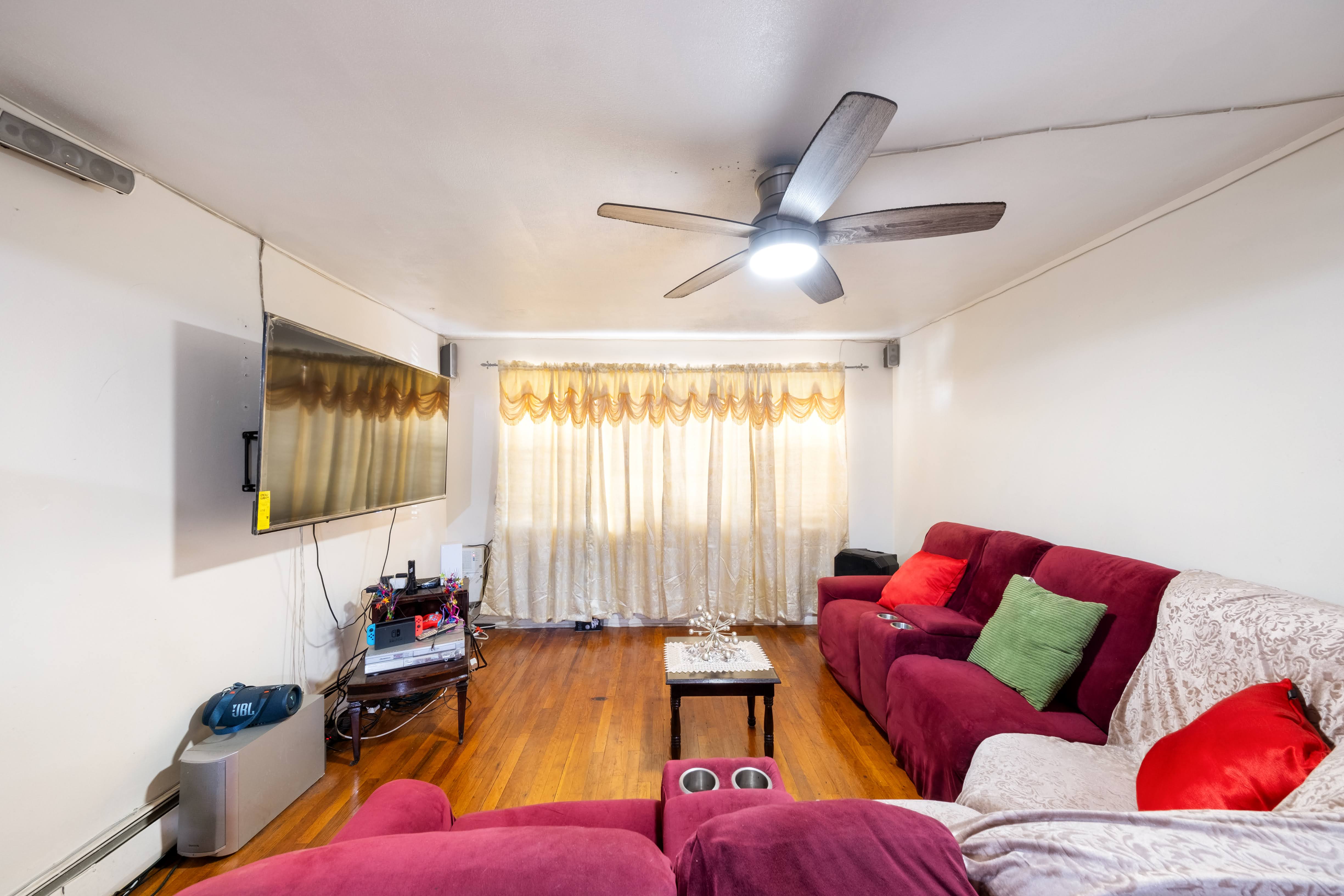 1464 East 84th Street Brooklyn, NY 11236 - Photo 2 of 22 a living room with furniture and a flat screen tv