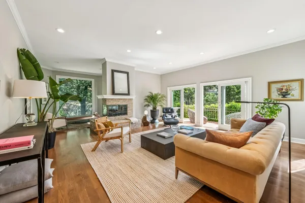 a living room with furniture fireplace and a large window