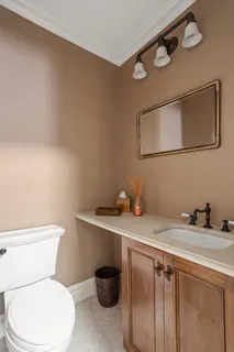 a white toilet sitting next to a bathroom sink