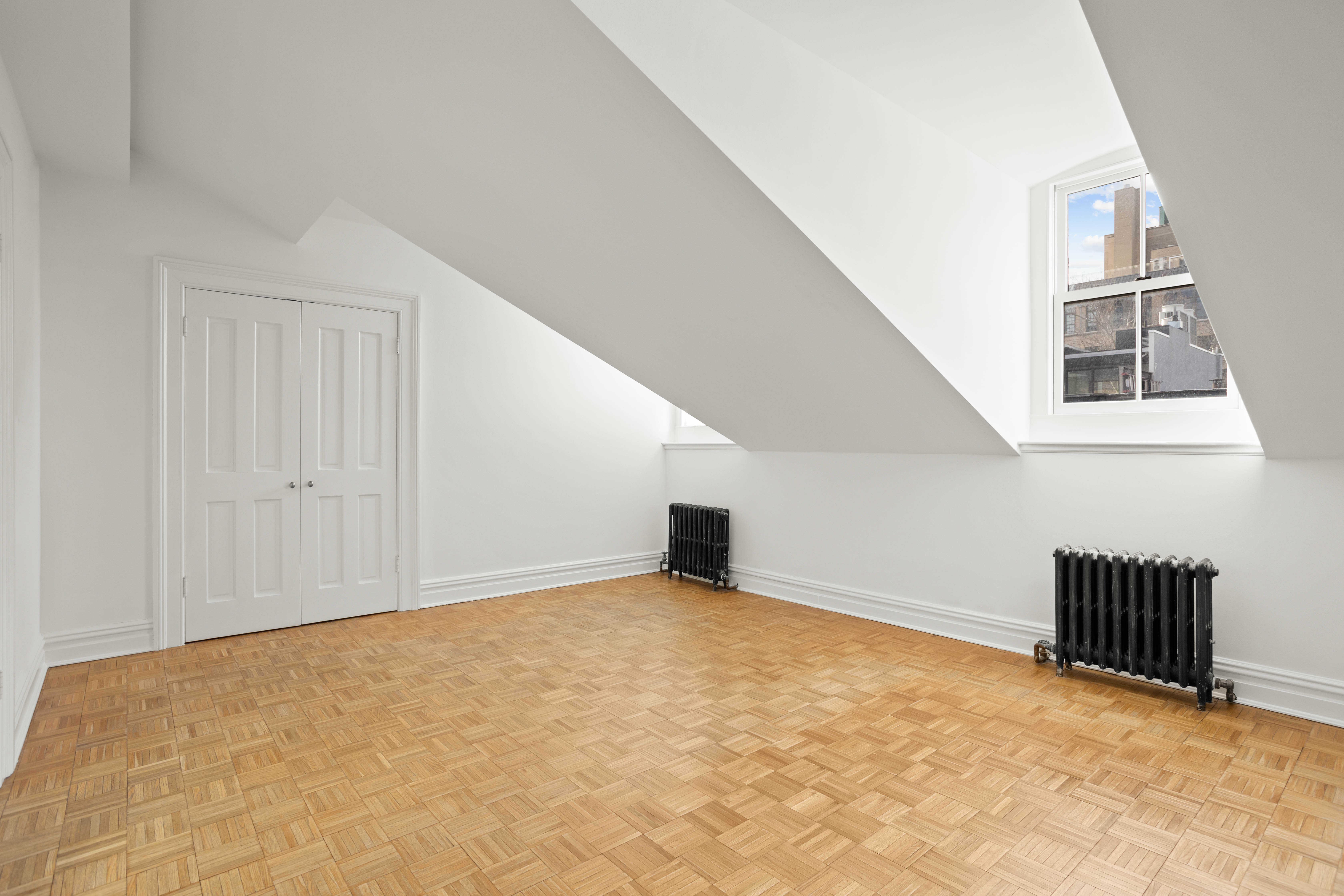 357 West 20th Street, Unit B Manhattan, NY 10011 - Photo 5 of 10 an empty room with windows