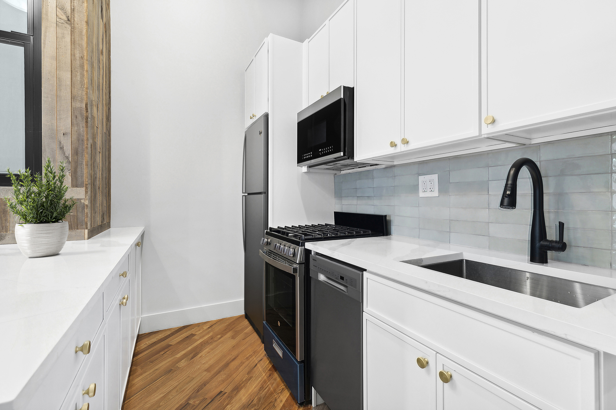 866 Bushwick Avenue, Unit 3 Brooklyn, NY 11221 - Photo 3 of 13 a kitchen with stainless steel appliances granite countertop a sink and a microwave