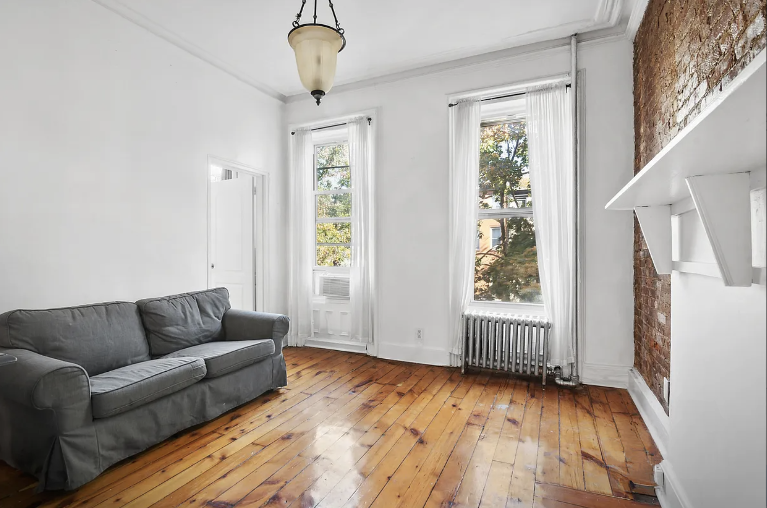 397 Clermont Avenue, Unit 3R Brooklyn, NY 11238 - Photo 1 of 8 a view of livingroom with furniture wooden floor and windows