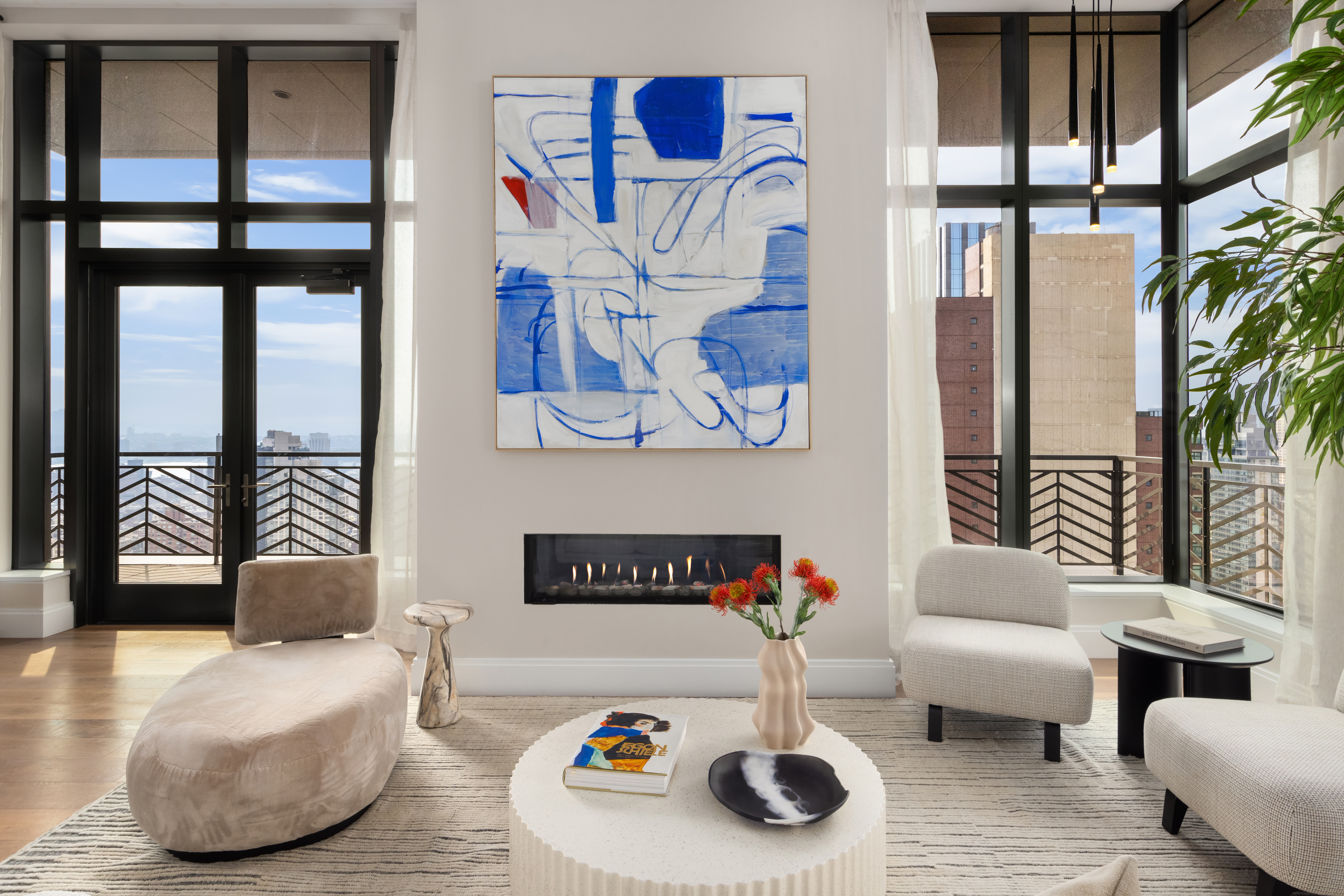 a living room with furniture and a floor to ceiling window